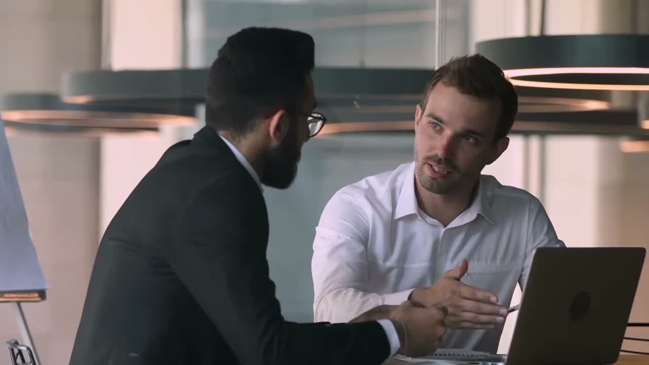 Agency consultant talking with a client across a laptop